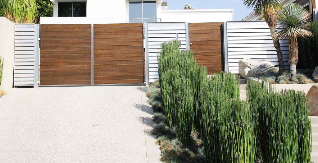 Horizontal wood and aluminum bifold auto gate and hinged pedestrian gate