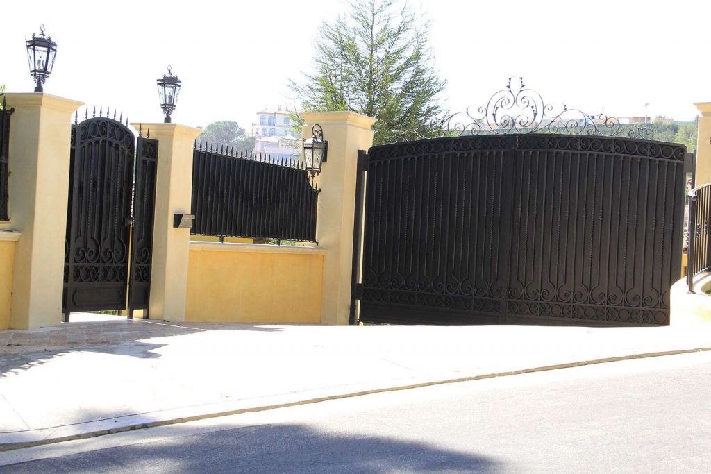 Black wrought iron and sheet metal pedestrian and auto gates