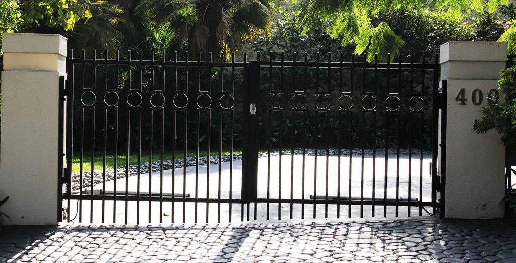 Contemporary steel and glass folding auto gate and hinged pedestrian gate