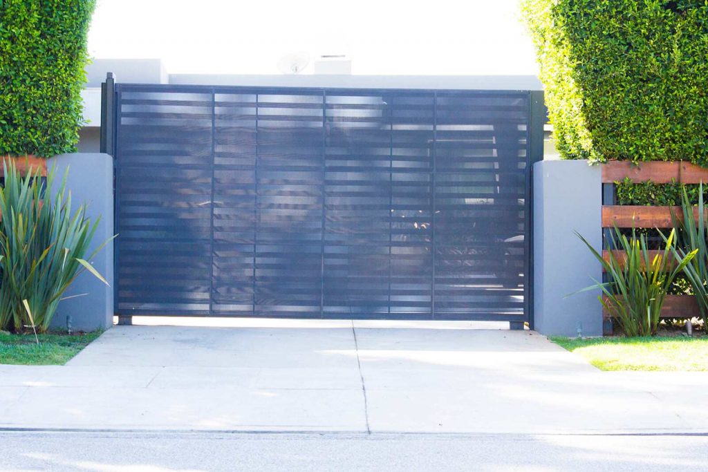 Black steel single slide gate with laser etched privacy screen