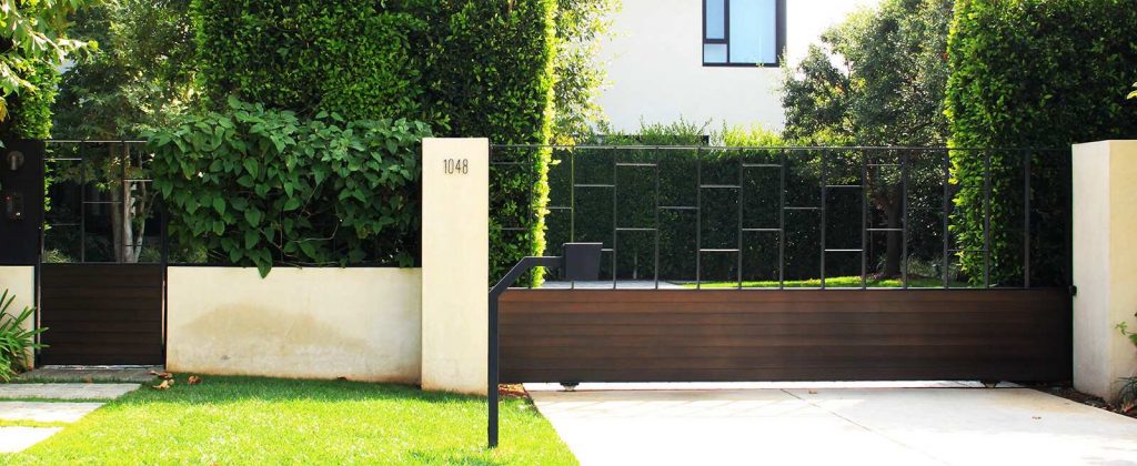 Contemporary wood and steel auto sliding gate and hinged pedestrian gate