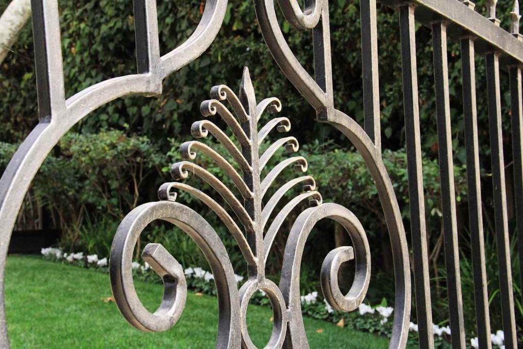 Intricate scroll work on wrought iron gate