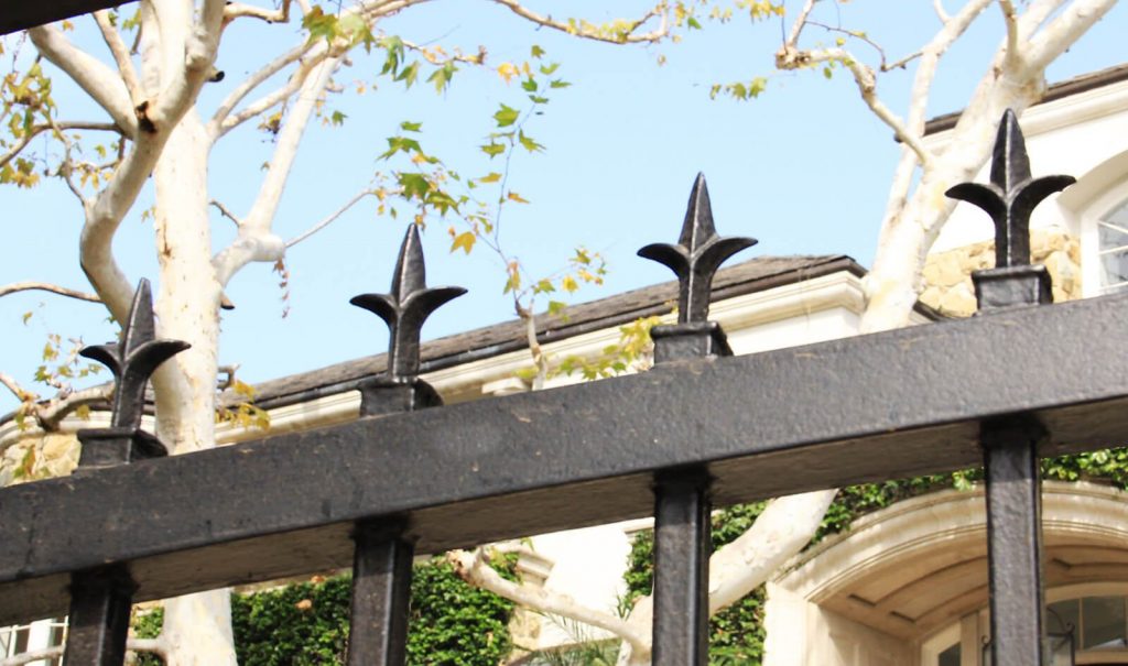 Close up of fleur-de-lis gate topper
