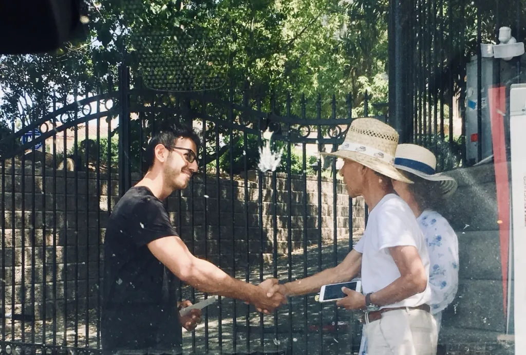 shawn closing his first gate project shaking hand with the clients