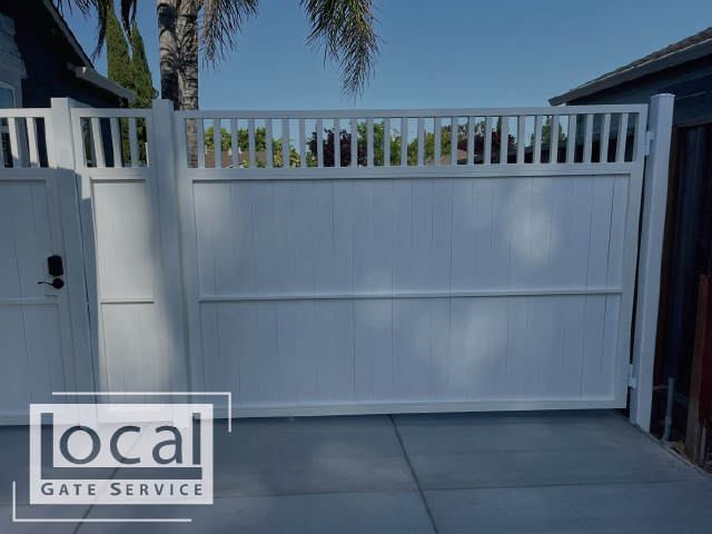 White painted wooden driveway gate with white powder coated metal frame